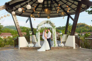 A bride and groom standing at the altar, saying “I do” at TAG Resort Coron’s Tanaw Pavilion event venue.